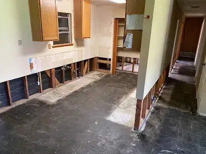 Flood cut through drywall in a kitchen and hallway after water spread