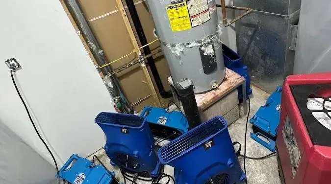 Drying equipment set up in a water heater closet after a leak