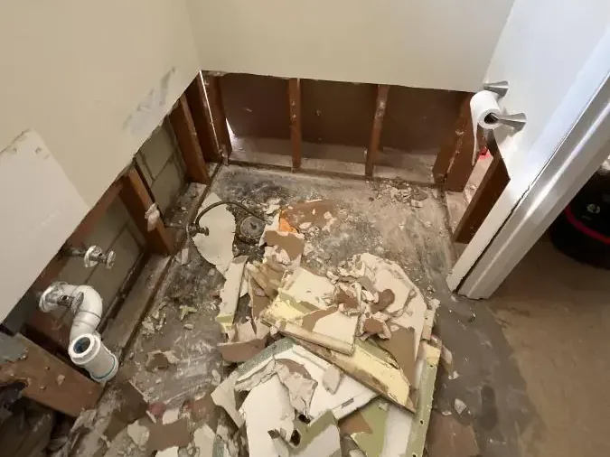 Bathroom stripped down to the wall studs and subfloor after a sewage backup